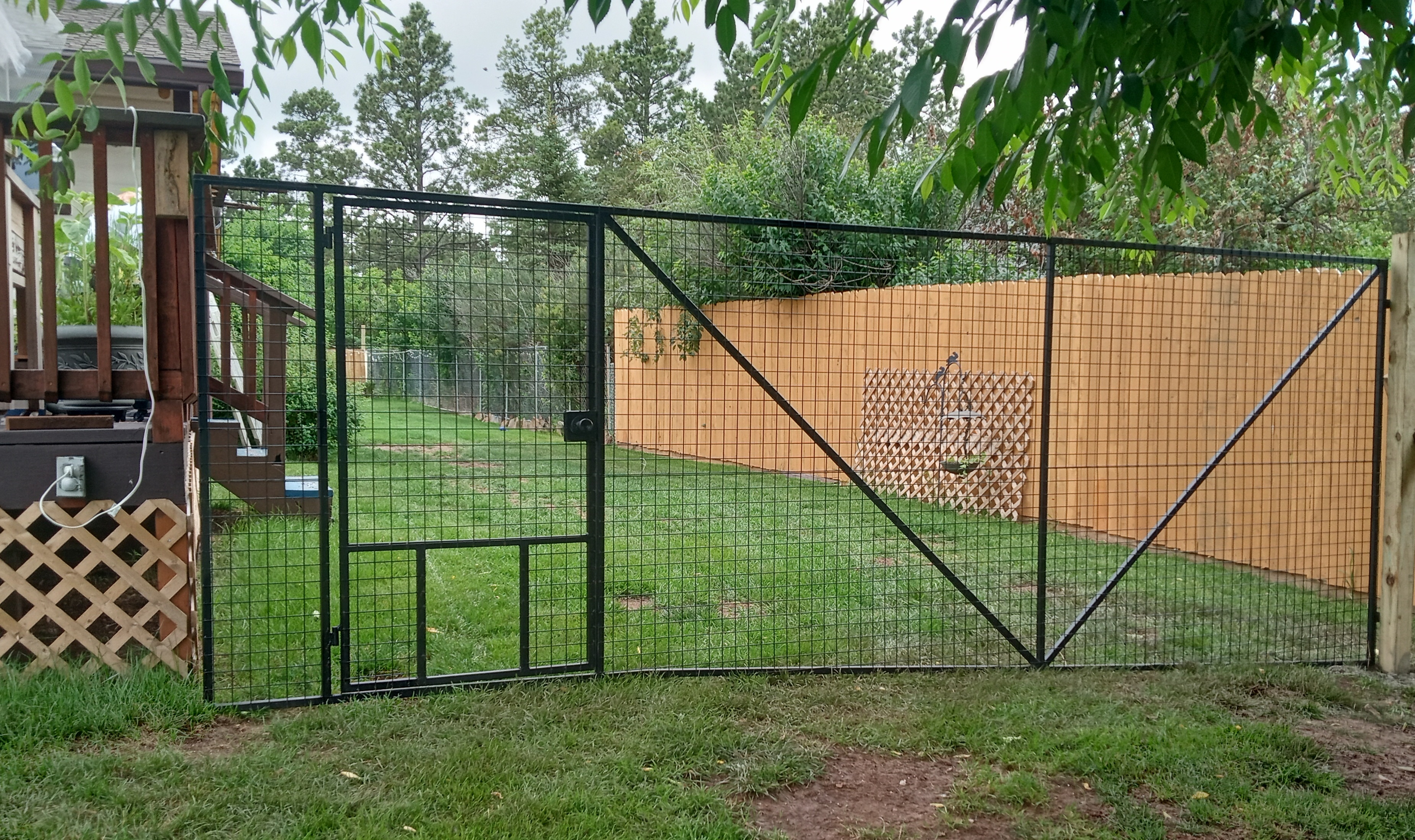 large steel swinging gate with door